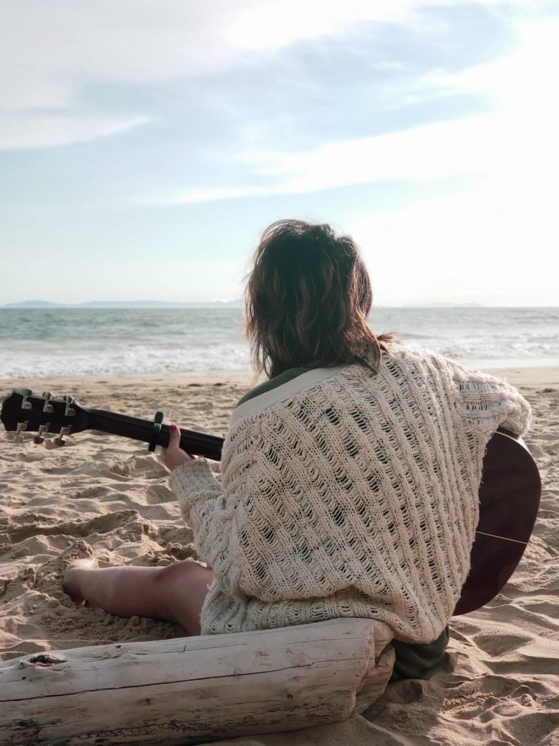 woman playing the acoustic guitar