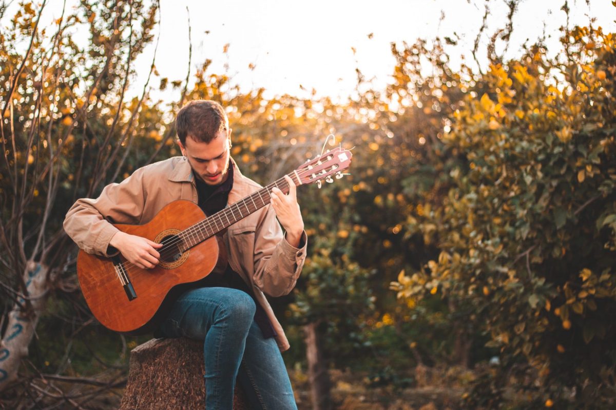 man playing an acoustic guitar